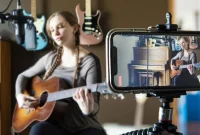 musician performing live acoustic session while viewer watches online